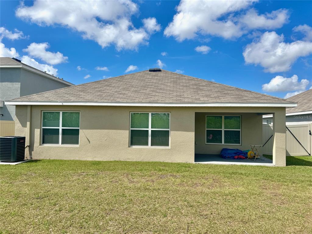 13374 Mylion Way Spring Hill, FL 34610 - Photo 36 of 39 a view of a house with a backyard