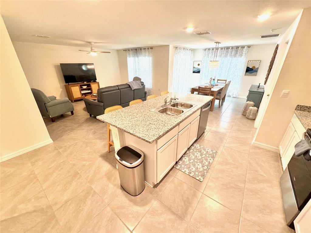 13374 Mylion Way Spring Hill, FL 34610 - Photo 6 of 39 a living room with a couch and a flat screen tv