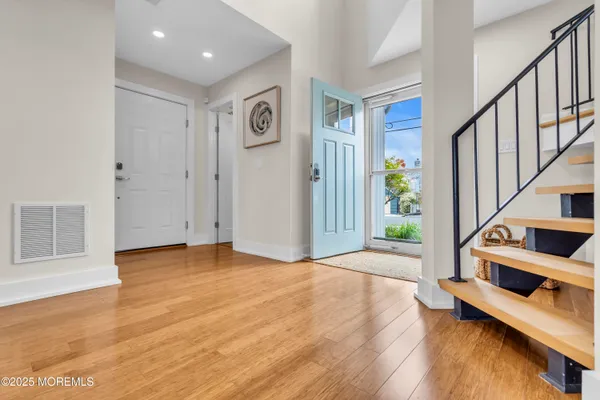 a view of an entryway with wooden floor
