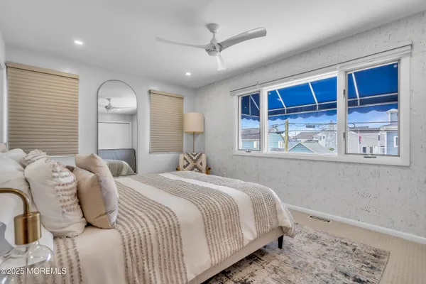 a bedroom with a large bed and a window