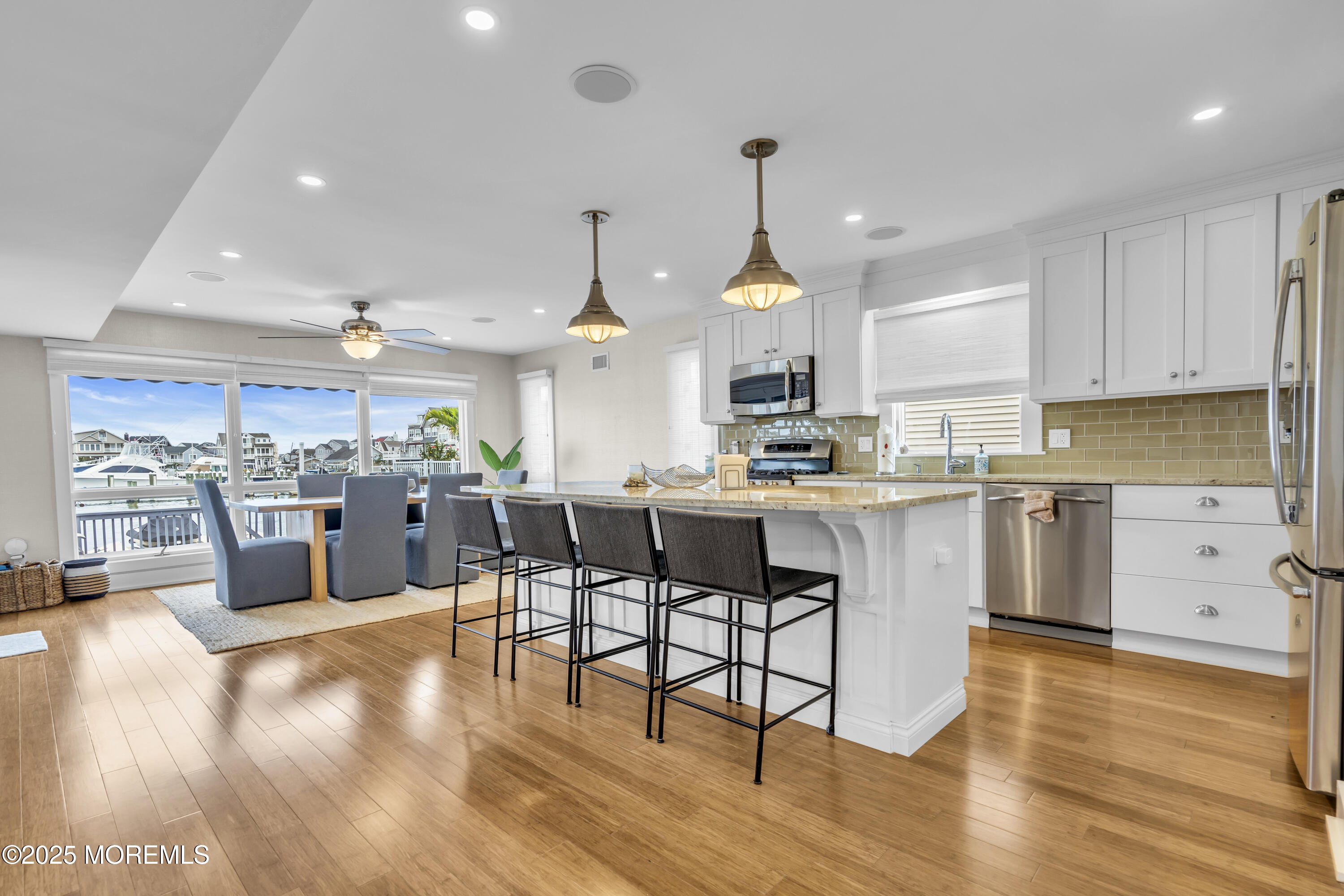 254 Harbor Court Lavallette, NJ 08735 - Photo 7 of 47 a kitchen with stainless steel appliances kitchen island granite countertop a sink cabinets and wooden floor