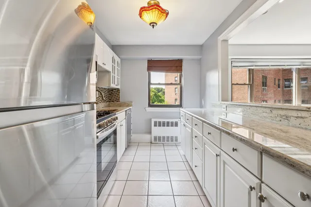 a large white kitchen with a stove a sink and a refrigerator