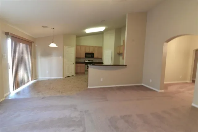 a view of a kitchen with a sink and a refrigerator