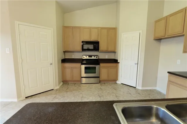 a kitchen with a stove and a microwave