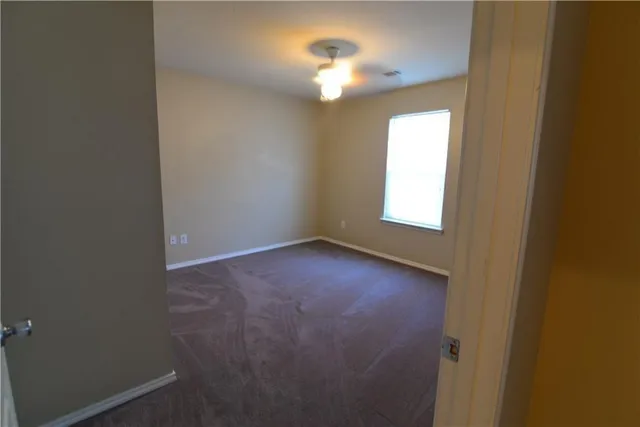 an empty room that has a window in it