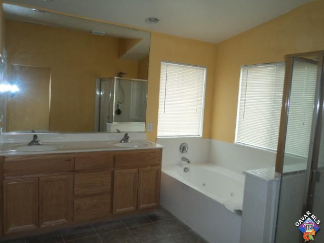 5753 Monaco Drive Palmdale, CA 93552 - Photo 13 of 29 a bathroom with a tub sink and mirror
