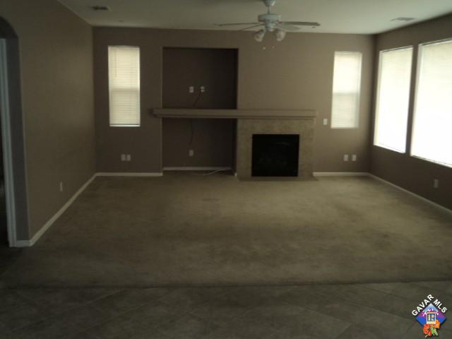 5753 Monaco Drive Palmdale, CA 93552 - Photo 5 of 29 an empty room with windows and fireplace