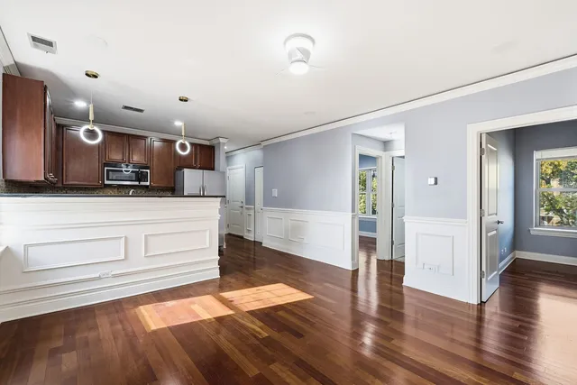 a view of kitchen with cabinets and wooden floor