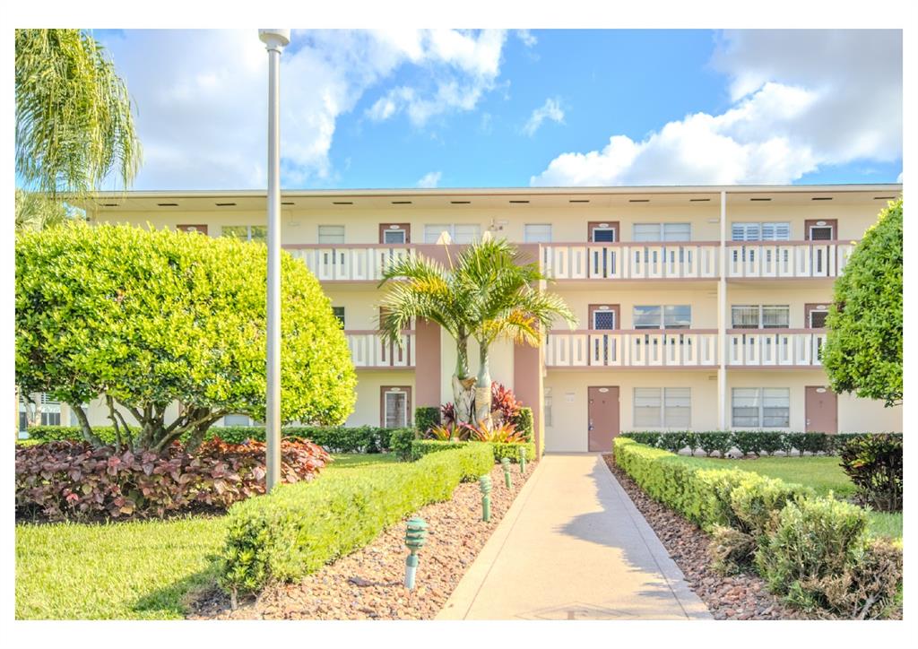 251 Preston F, Unit 251 Boca Raton, FL 33434 - Photo 4 of 35 a front view of a building with a garden