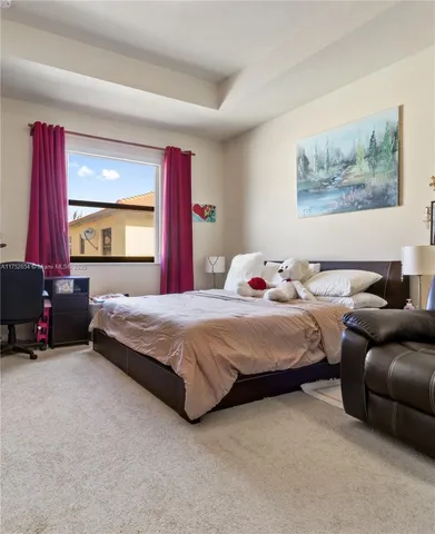 a bedroom with a bed a couch and dresser