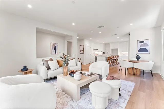 a living room with furniture a table and a potted plant