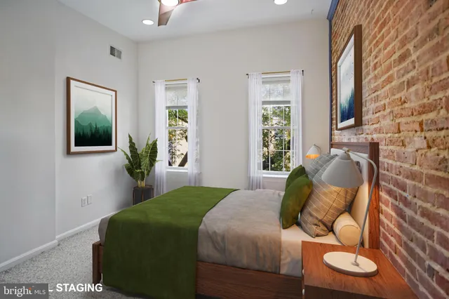 a bedroom with a bed and mirror