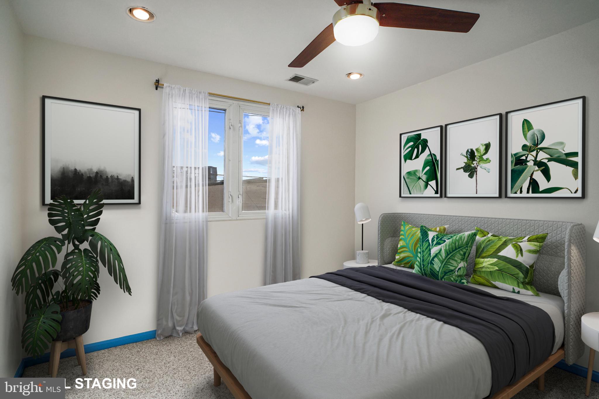 1417 Covington Street Baltimore, MD 21230 - Photo 16 of 25 a bedroom with a bed and a potted plant