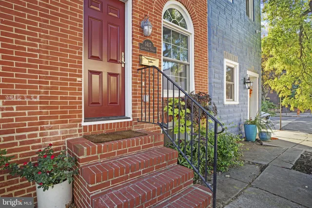 a view of a brick house with many windows