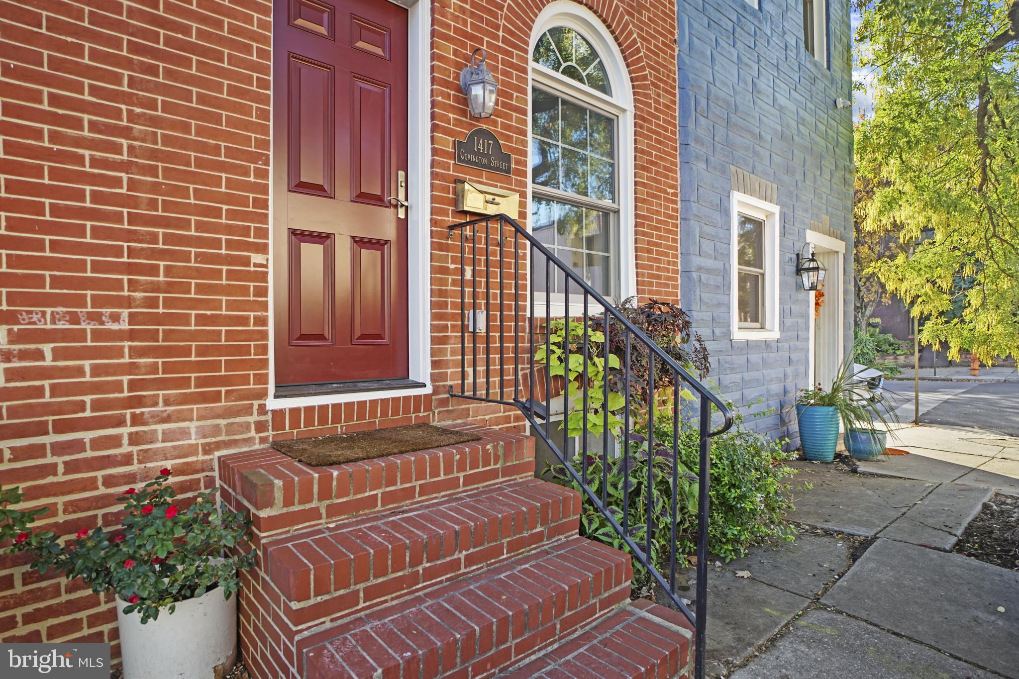 1417 Covington Street Baltimore, MD 21230 - Photo 2 of 25 a view of a brick house with many windows