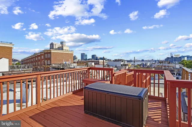 a view of a balcony with wooden benches