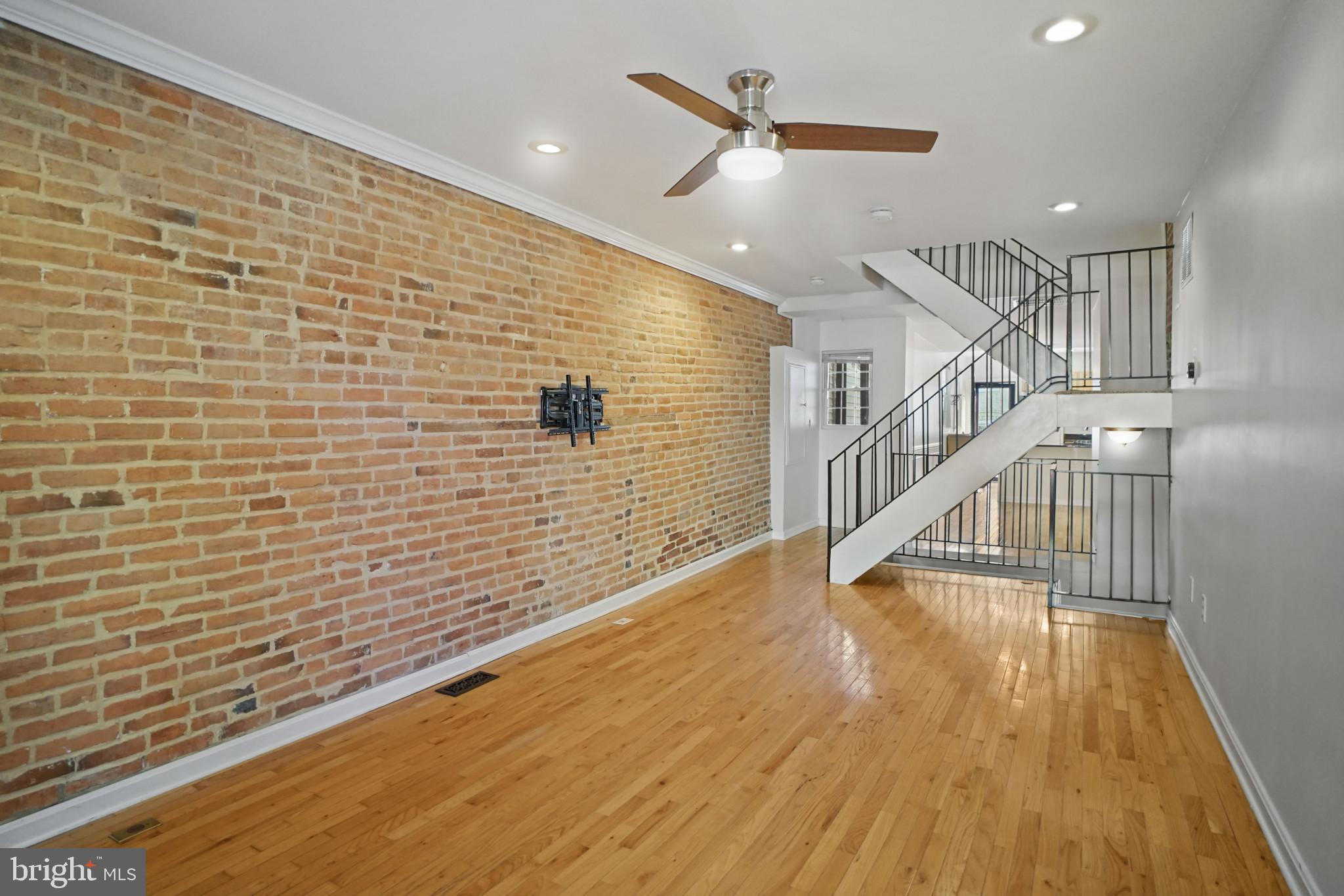 1417 Covington Street Baltimore, MD 21230 - Photo 3 of 25 a view of a hallway with wooden floor