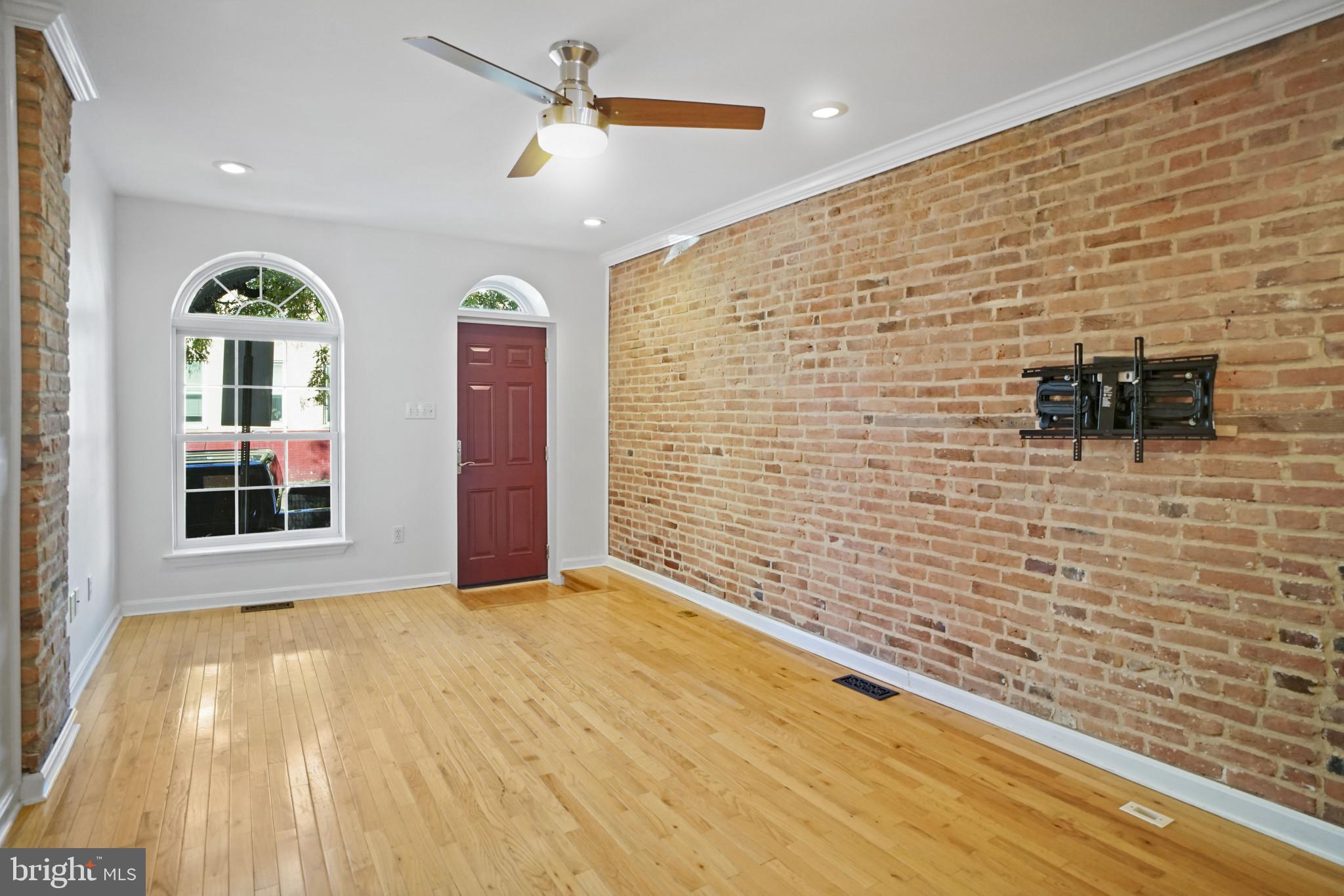 1417 Covington Street Baltimore, MD 21230 - Photo 4 of 25 a view of empty room with windows