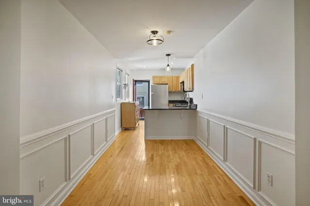 a view of a kitchen with wooden floor
