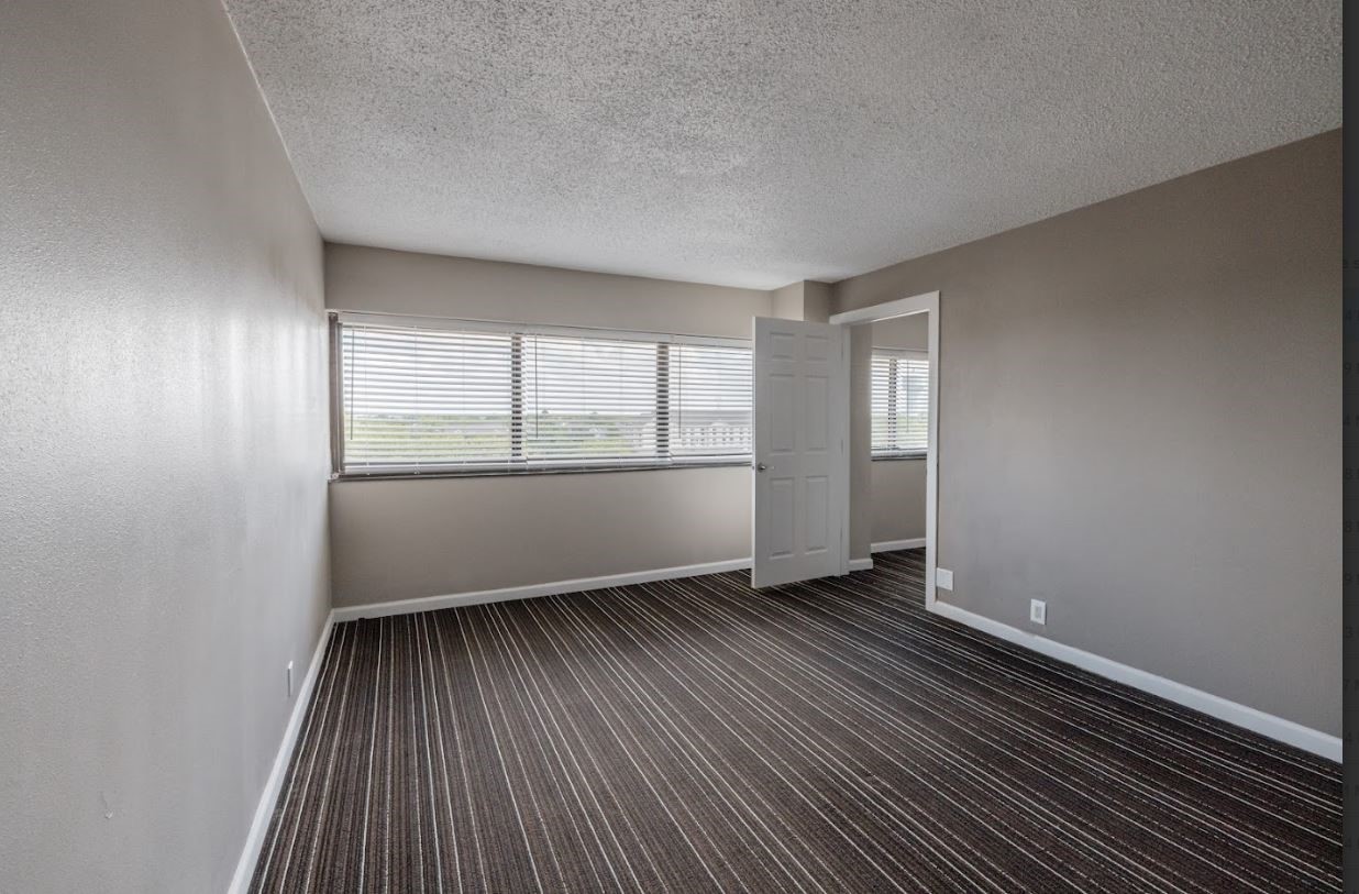14703 Park Row Houston, TX 77079 - Photo 37 of 40 an empty room with wooden floor and windows
