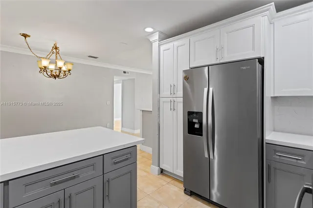 a kitchen with cabinets and stainless steel appliances
