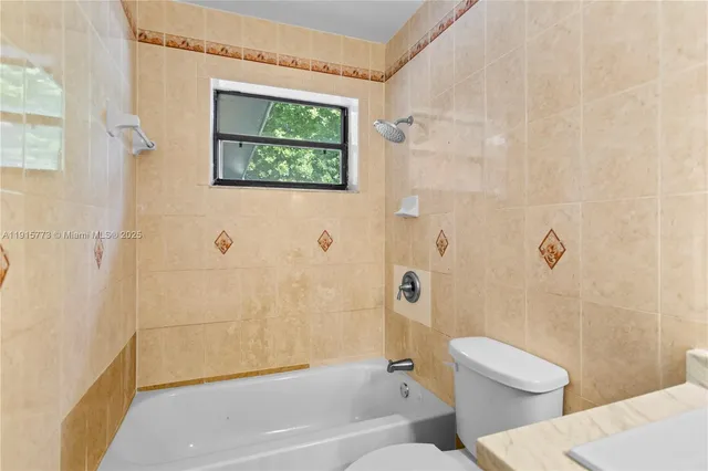 a bathroom with a toilet and a bathtub