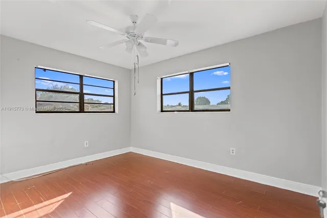 a view of a room with wooden floor and window
