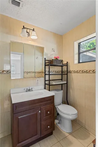 a bathroom with a toilet a sink and a mirror