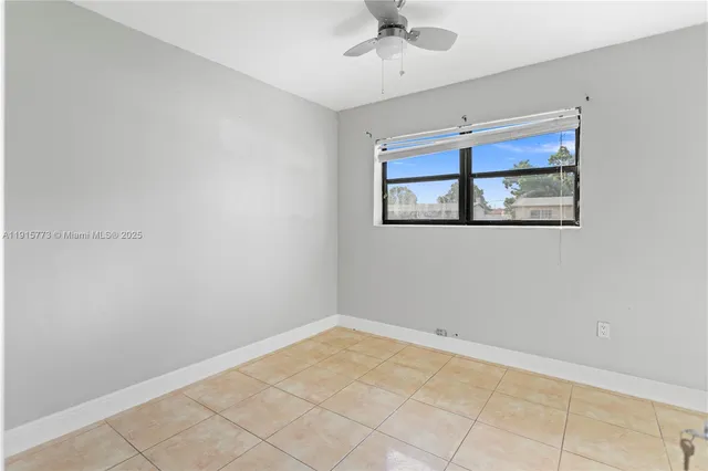 a view of room with window and ceiling fan