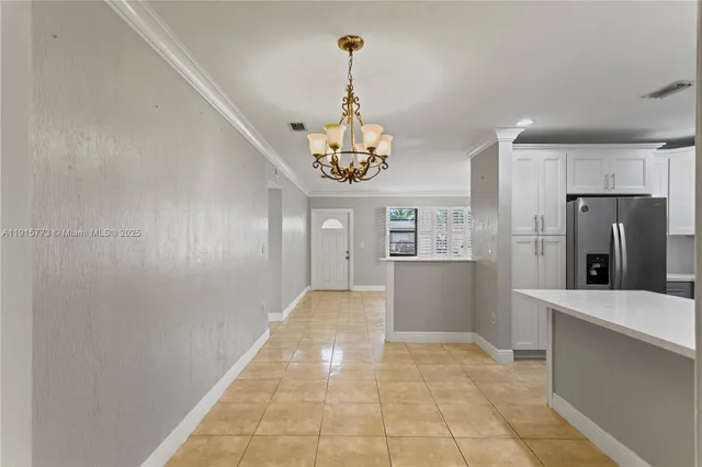 a view of a kitchen with a sink and refrigerator