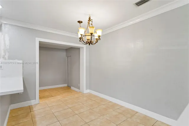 a view of a chandelier in big room and chandelier fan