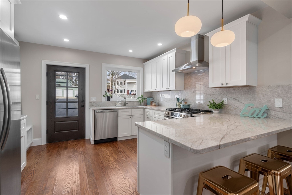79 Read Street Winthrop, MA 02152 - Photo 11 of 33 a kitchen with a stove cabinets and wooden floor