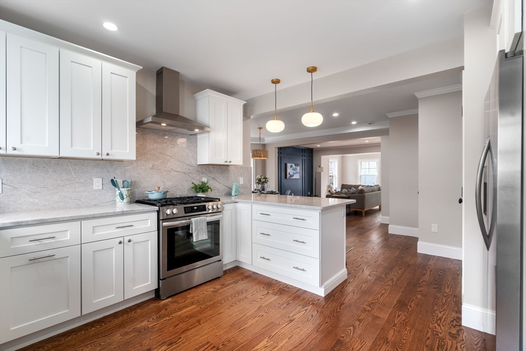 79 Read Street Winthrop, MA 02152 - Photo 12 of 33 a kitchen with white cabinets and stainless steel appliances