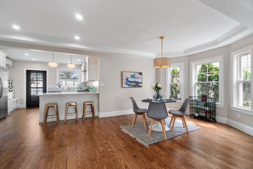 79 Read Street Winthrop, MA 02152 - Photo 18 of 33 a dining room with wooden floor a chandelier a wooden table and chairs