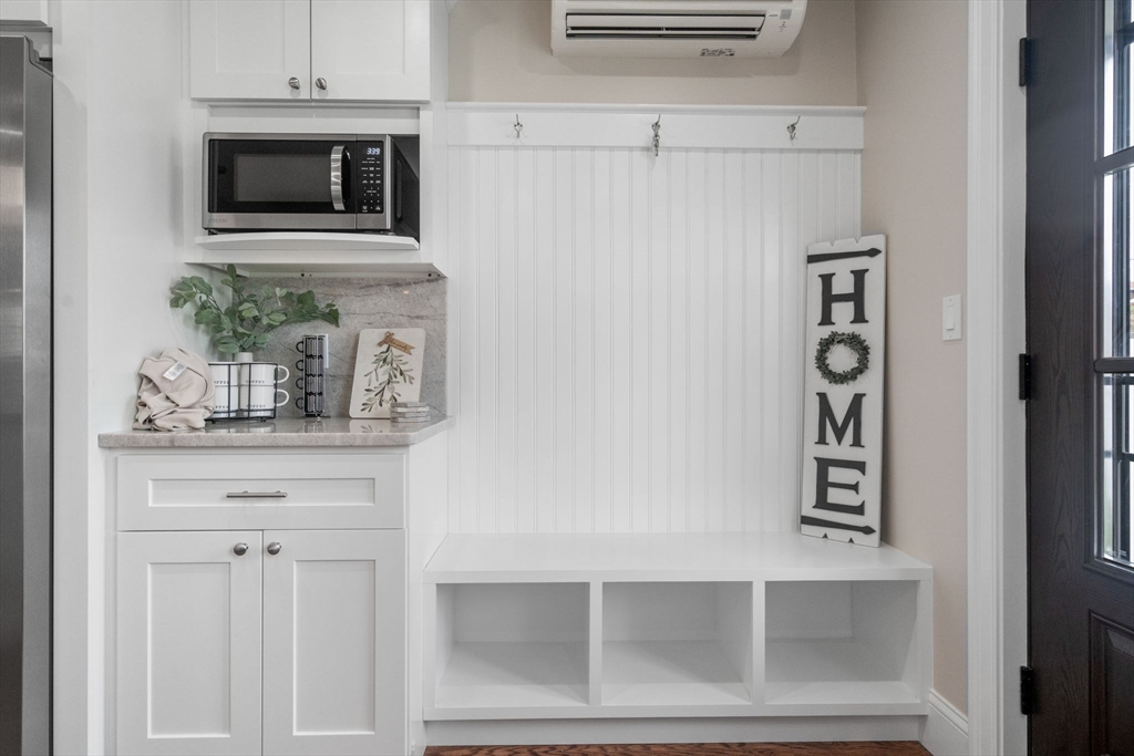 79 Read Street Winthrop, MA 02152 - Photo 8 of 33 a kitchen with white cabinets and microwave