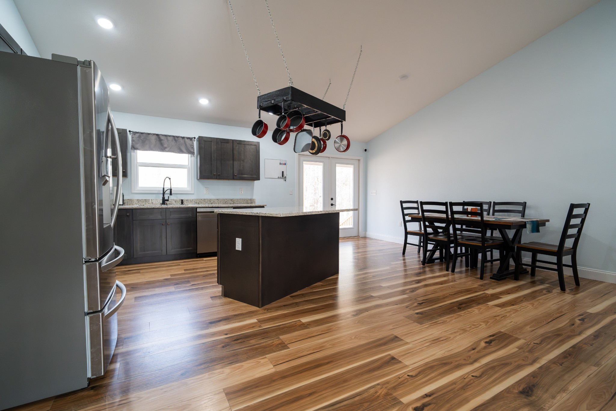 1561 Bicknell Road Clarkrange, TN 38553 - Photo 18 of 44 a kitchen with stainless steel appliances granite countertop a table chairs and a refrigerator