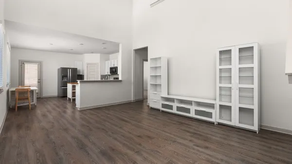 a view of a kitchen with wooden floor and windows