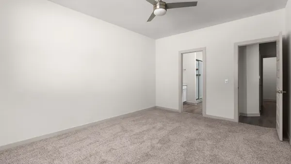 an empty room with a empty space and windows