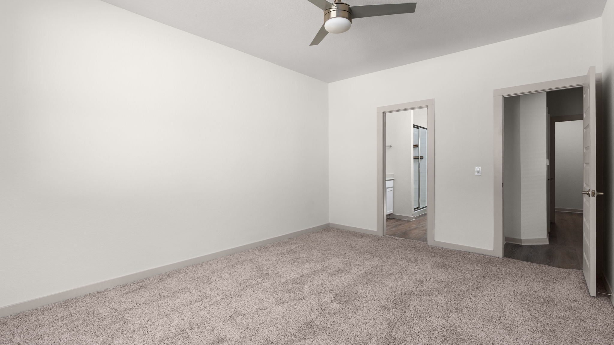 101 Merrick Road Georgetown, TX 78628 - Photo 19 of 38 First floor, primary bedroom with light colored carpet and ceiling fan