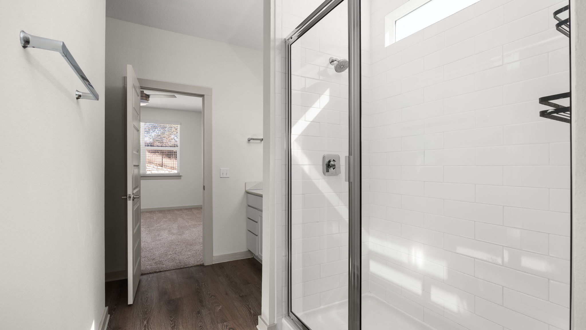 101 Merrick Road Georgetown, TX 78628 - Photo 22 of 38 Bathroom featuring healthy amount of natural light, a stall shower, dark wood-type flooring, and vanity