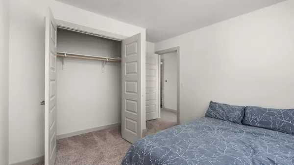 a bedroom with a bed and a walk in closet