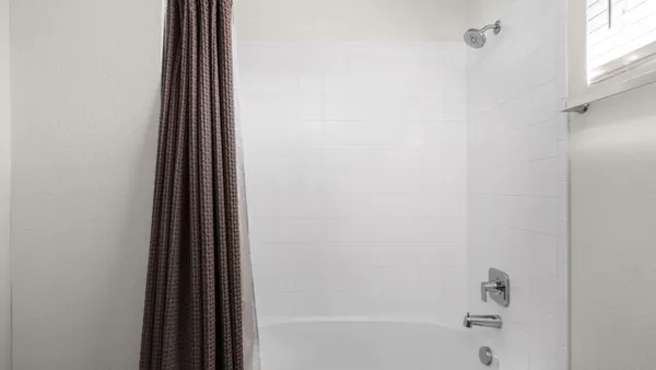 a bathroom with a bathtub and a window