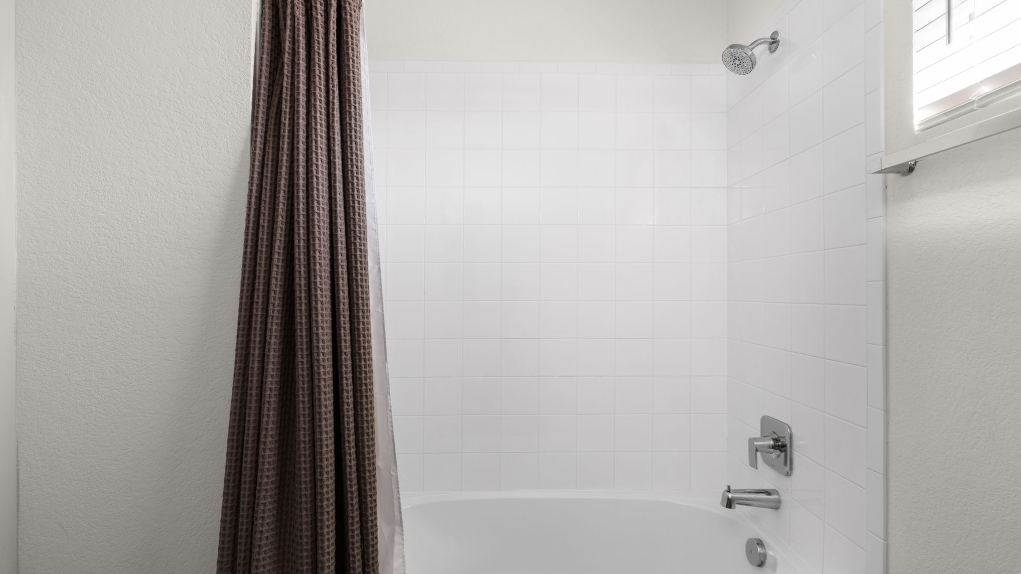 101 Merrick Road Georgetown, TX 78628 - Photo 30 of 38 Bathroom with shower / tub combo and a textured wall