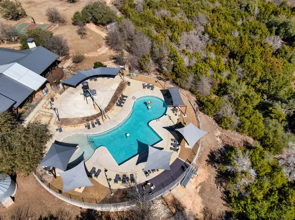 an aerial view of a house with a yard basket ball court and outdoor seating