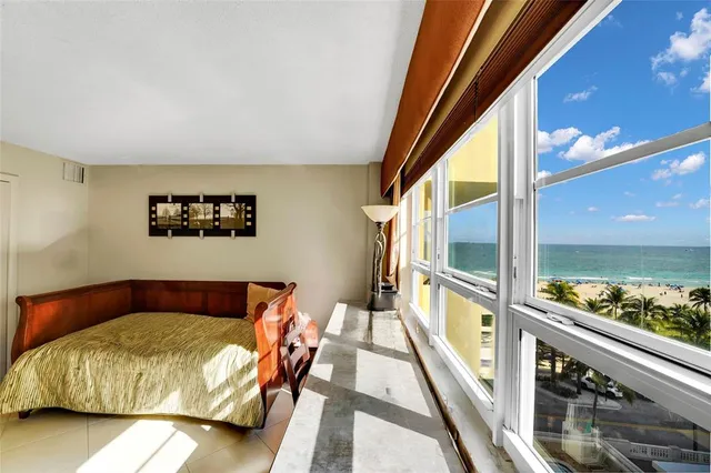 a bedroom with a bed and glass window