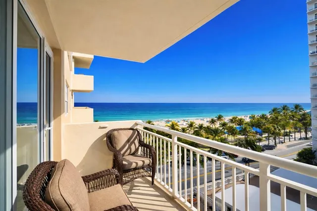 a view of a chairs and table on the balcony