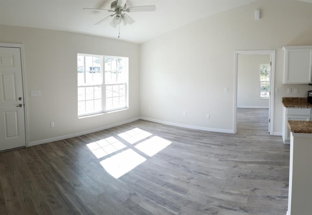 9 Fir Trail Ocala, FL 34472 - Photo 3 of 11 wooden floor in an empty room with a window