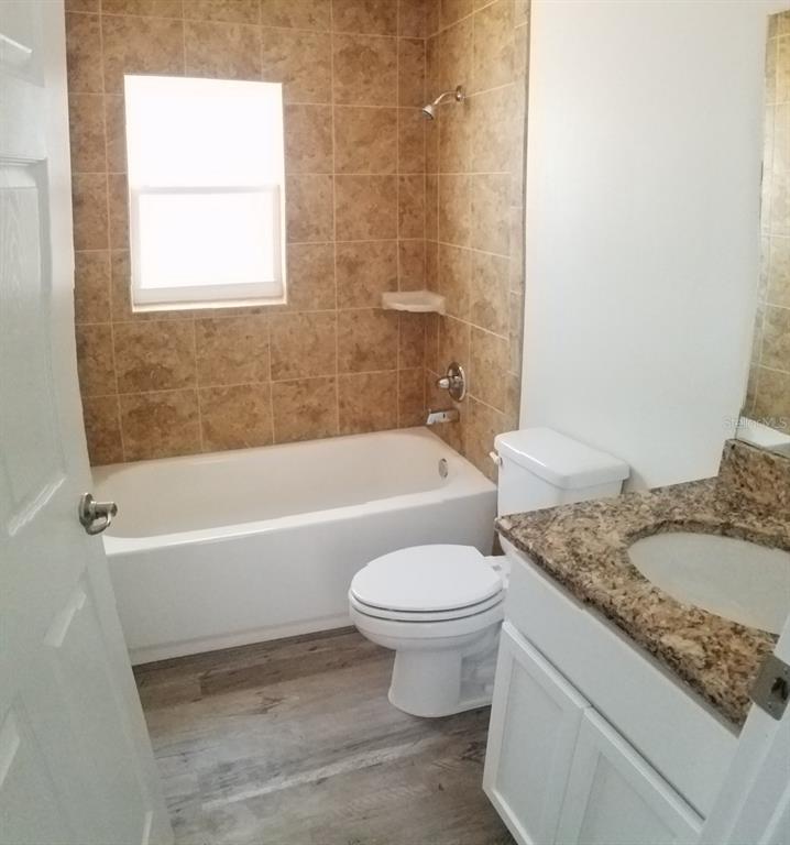 9 Fir Trail Ocala, FL 34472 - Photo 9 of 11 a bathroom with a granite countertop toilet a sink and bathtub