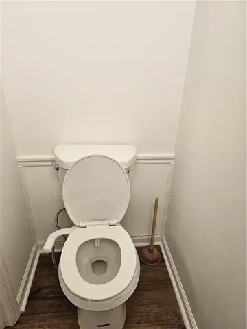 a close view of a toilet in a small room