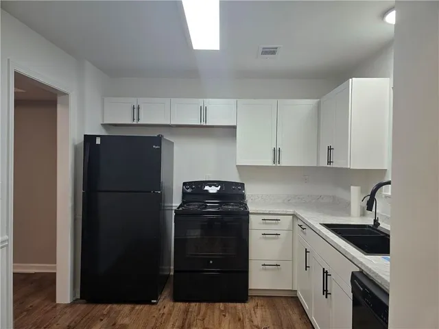 a kitchen with a sink and a refrigerator